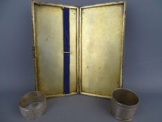Large silver cigarette case and two hallmarked napkin rings, 10.6 troy ozs gross, Chester 1932 the