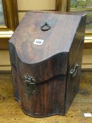 A serpentine Georgian mahogany twin-handled knife box with fitted interior and brass mounts