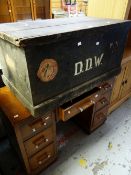 A vintage painted pine cabin trunk bearing old passenger-line labels together with a vintage desk