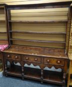 A Victorian oak Welsh dresser having a planked platform base, three drawers and an open rack with