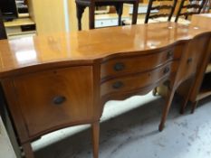 A reproduction inlaid mahogany serpentine sideboard Condition reports provided on request by email