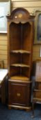 A reproduction standing mahogany narrow corner unit with cupboard base and open shelf top having