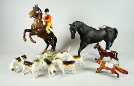 A Beswick model of a rearing mounted huntsman with seperate fox and six hounds together with a