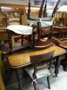 An Edwardian mahogany extending wind out dining table (winder with us) together with six chairs,