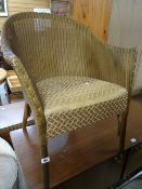 A golden coloured Lloyd Loom cushion seated chair Condition reports provided on request by email for