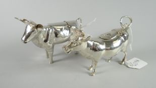 A pair of continental Schuppe-style silver creamers in the form two horned calves with loop tails as