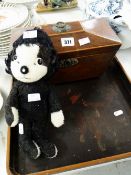 A nineteenth century mahogany sarcophagus tea caddy, a vintage Merrythought character soft toy and a