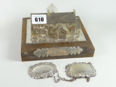 A mounted silver model of Long Oaks Cottage, Penmaen, Swansea (an historic house) on a wooden