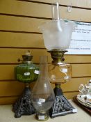 Two vintage glass reservoir oil lamps on metal bases Condition reports provided on request by