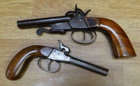 A nineteenth century double barrel percussion pistol with carved detail to the curved handle