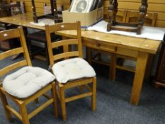 A twentieth century farmhouse table with centre drawer, 126cms long together with four ladder back