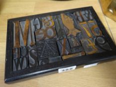 A framed arrangement of printers blocks including a copper mounted pointing finger, 21 x 14cms (
