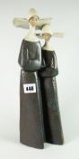 A Lladro pottery model of two standing nuns, 33cms high Condition reports provided on request by