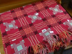 A good traditional Welsh wool blanket in pink ground with black yellow duck egg blue and flecked