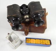 A vintage leather cased set of sporting binoculars together with a boxed miniature stereoscope