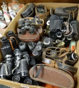 A large collection of mixed vintage binoculars including some military examples noted, varying