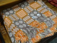 A traditional Welsh wool blanket in orange and green ground decorated in geometric squares Condition