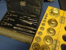 A fitted wooden boxed set of vintage laboratory brass weights, bearing label to the box for
