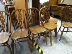 A set of twentieth century country oak wheel back dining chairs Condition reports provided on