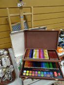 A Daler-Rowney table easel and a modern suitcase containing art materials and a washboard