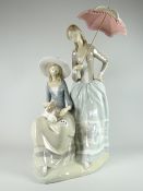 A large Lladro pottery model of two ladies - one seated with puppy, the other standing with parasol,