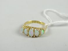 An 18ct yellow gold antique ring set with five graduated oval opals Condition reports provided on