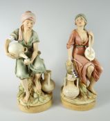 A pair of Royal Dux models being an Arabian boy and girl, the boy in traditional dress pouring water