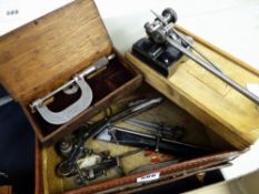 A vintage vanity case containing vintage engineering tools including callipers, lathe mount (take