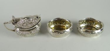 Matched three-piece silver condiment set comprising a pair of 925 repousse salts and similar