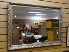 A modern gilt framed bevelled wall mirror Condition reports provided on request by email for this