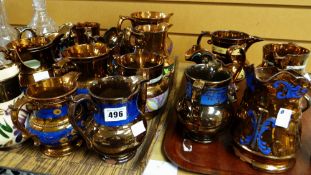 A collection of nineteen copper lustre jugs and a copper lustre cup Condition reports provided on