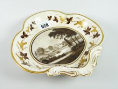 A Swansea porcelain dessert dish circa 1805 of clover form with moulded handle and centred with a