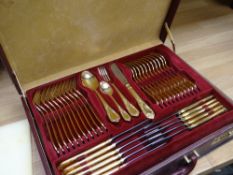 Cased canteen of Nivella Solingen cutlery, gold plated in fitted suitcase with pamphlet and original