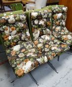 A set of six mid-century swivel armchairs with floral cushion seats raised over chrome spider
