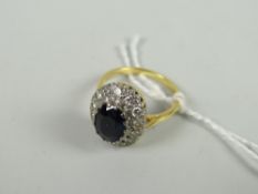 An 18ct yellow gold set diamond chip and centred sapphire oval ring Condition reports provided on