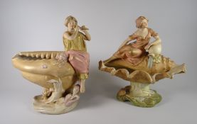 A pair of Royal Dux pottery ornaments each of typical form with classical-type figures resting on