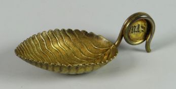 A Georgian silver caddy spoon in the form of a textured leaf with twisting handle bearing engraved