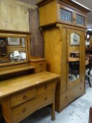 An Arts & Crafts oak wardrobe, 204cms high x 105cms wide and matching dressing table, 99cms wide,