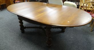 Twentieth century oak extending D-ended dining table having two lift out additional leaves, fretwork
