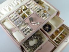 A modern light pink leather covered jewellery box with drawers containing a good assortment of