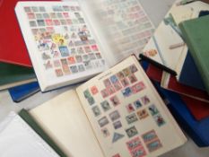 A brown cardboard carton containing various stamp albums including 'Simple Blank Album' in red,