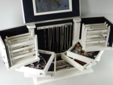 A cream wood concertina jewellery box and contents including silver dress rings, necklaces ETC