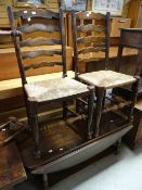 A country oak drop flap Long John coffee table with platform shelf together with a pair of rush