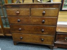 A Victorian chest of three long and two short drawers with marquetry detail and turned handles,