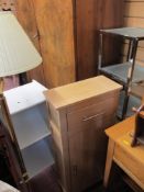 Metal and glass shelving unit, slim white shelving unit, light wood cabinet and a brass effect