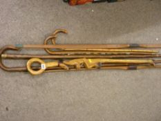 Two vintage bows, a shepherd's crook, a carved African walking stick and two others etc