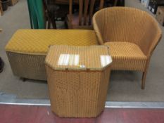 Three items of gold coloured Lloyd loom furniture