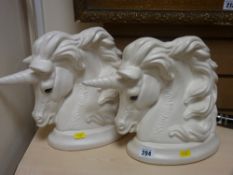 Pair of pottery unicorn heads