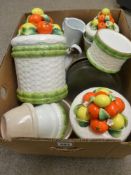 Box of colourful pottery containers, kitchen bowls and other goods