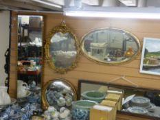 Four gilt framed wall mirrors and an oak framed example